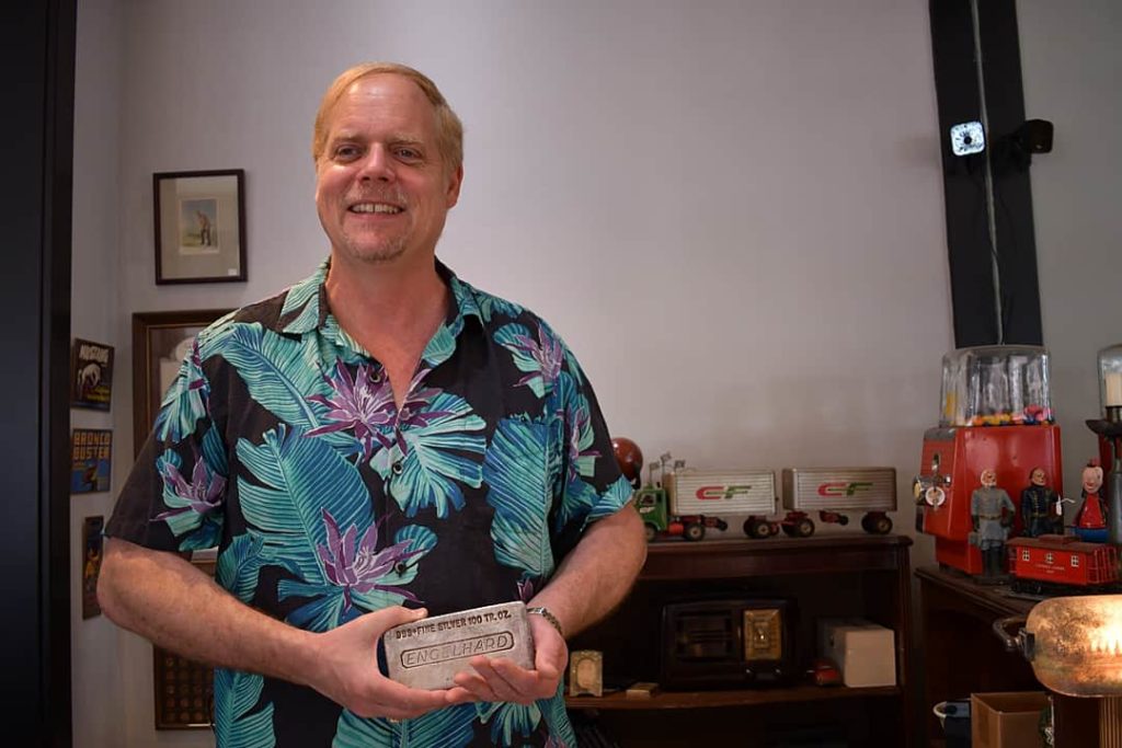 John Zalesny, owner of Pismo Beach Coins Etc Gallery, holds bar of silver bullion