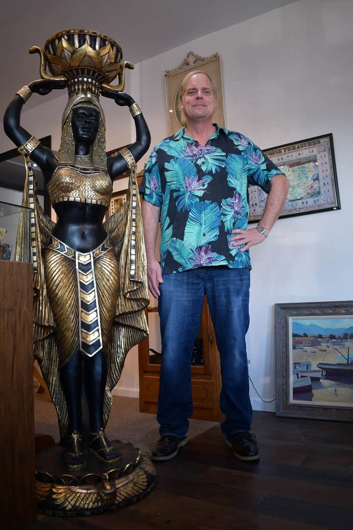 Pismo Beach Coins Etc Gallery owner John Zalesny next to life-size Nubian Princess statue